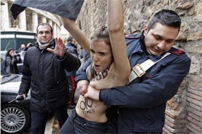 Полицай смачка бюста на феминистка, протестираща пред папата (снимки)